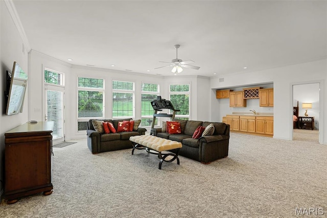 living room featuring ornamental molding, light colored carpet, a ceiling fan, and recessed lighting