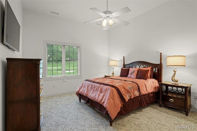 carpeted bedroom with baseboards and a ceiling fan