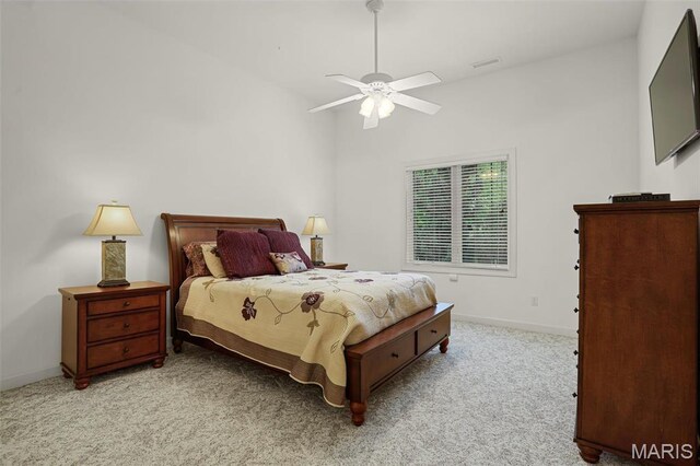 carpeted bedroom with baseboards, a ceiling fan, and vaulted ceiling