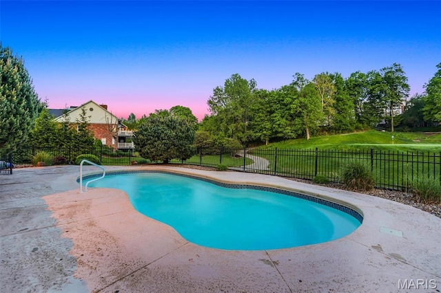 pool at dusk with a patio