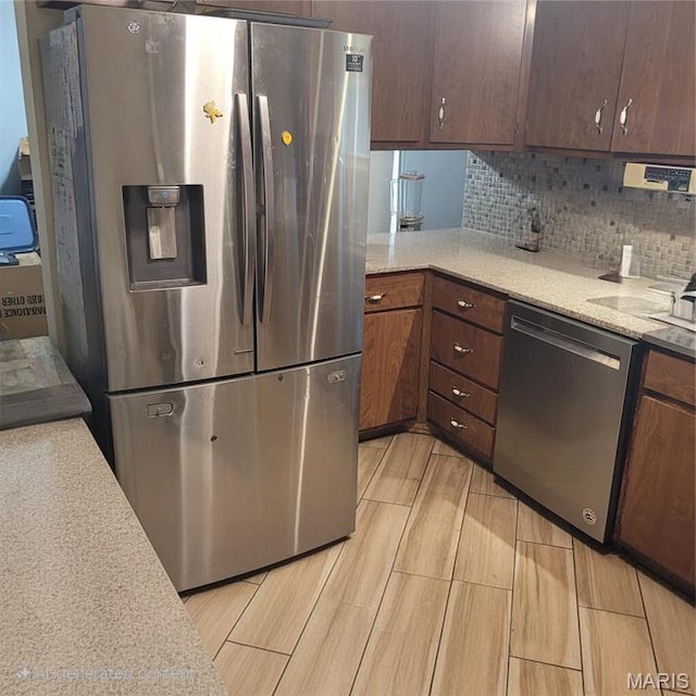 2 Hyannis Ct, Saint Charles, MO 63301 - kitchen featuring appliances with stainless steel finishes, decorative backsplash, and wood finish floors