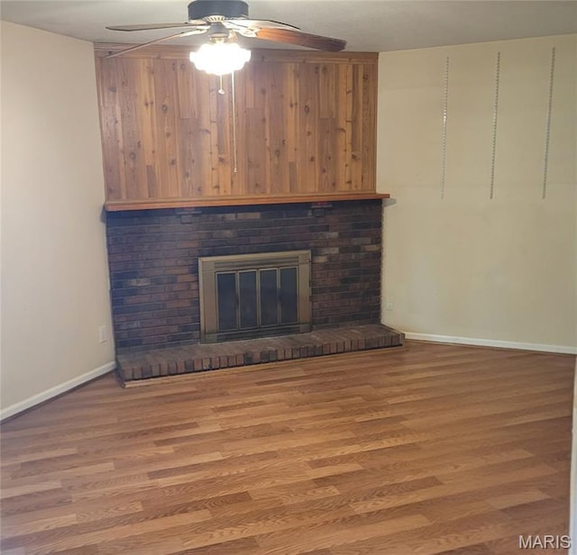 2 Hyannis Ct, Saint Charles, MO 63301 - unfurnished living room with ceiling fan, wood finished floors, and a brick fireplace