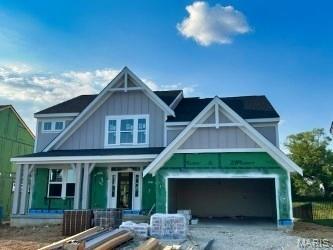 226 Talbot Way, Wentzville, MO 63385 - view of front of house featuring board and batten siding, a porch, and a garage