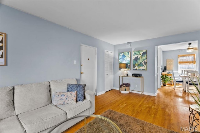5872 Sunshine Dr Unit 110, Saint Louis, MO 63109 - living room with wood finished floors, a ceiling fan, and baseboards