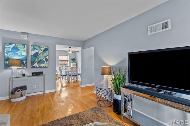 5872 Sunshine Dr Unit 110, Saint Louis, MO 63109 - living area with wood finished floors and baseboards