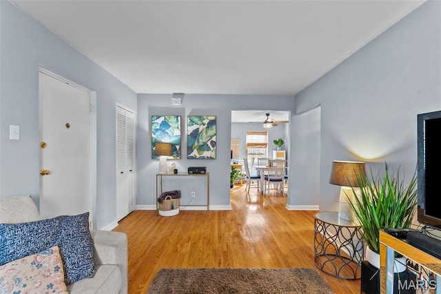 5872 Sunshine Dr Unit 110, Saint Louis, MO 63109 - living room with wood finished floors, baseboards, and a ceiling fan