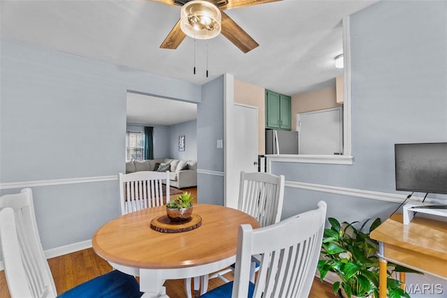 5872 Sunshine Dr Unit 110, Saint Louis, MO 63109 - dining area with a ceiling fan, wood finished floors, and baseboards