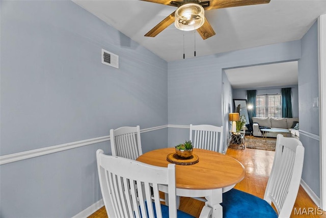 5872 Sunshine Dr Unit 110, Saint Louis, MO 63109 - dining space with a ceiling fan, wood finished floors, and baseboards