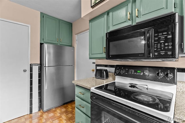5872 Sunshine Dr Unit 110, Saint Louis, MO 63109 - kitchen with freestanding refrigerator, range with electric stovetop, black microwave, green cabinets, and light countertops