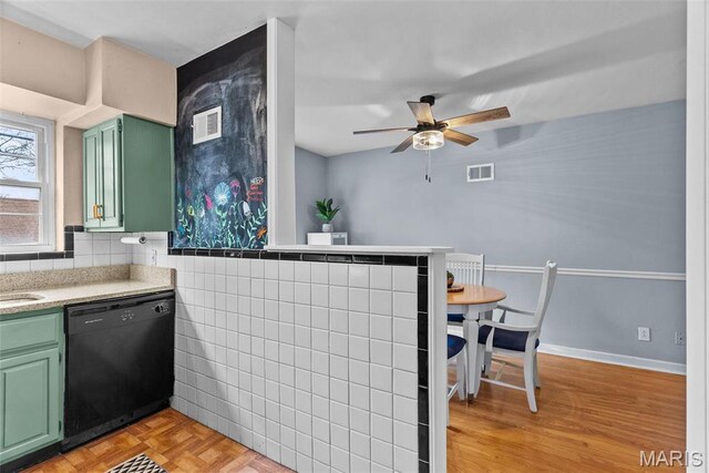 5872 Sunshine Dr Unit 110, Saint Louis, MO 63109 - kitchen with black dishwasher, green cabinetry, a ceiling fan, and light countertops