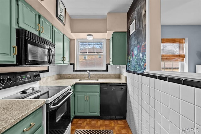 5872 Sunshine Dr Unit 110, Saint Louis, MO 63109 - kitchen featuring black appliances, green cabinets, a sink, and light countertops