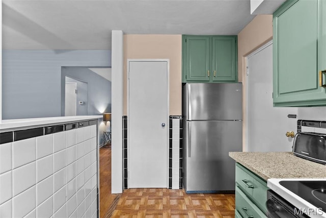5872 Sunshine Dr Unit 110, Saint Louis, MO 63109 - kitchen featuring green cabinetry, freestanding refrigerator, and electric stove