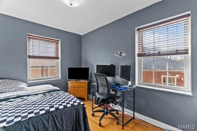 5872 Sunshine Dr Unit 110, Saint Louis, MO 63109 - bedroom featuring wood finished floors, baseboards, and a desk