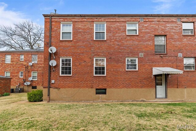 5872 Sunshine Dr Unit 110, Saint Louis, MO 63109 - view of property exterior with brick siding and a lawn