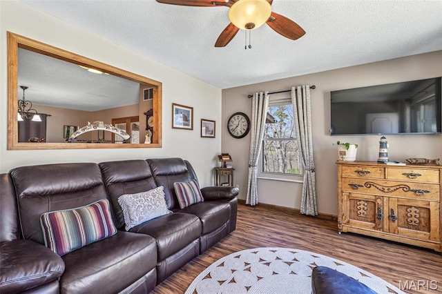 13145 Wanda Lee Ln, Saint Genevieve, MO 63670 - living area with ceiling fan, wood finished floors, baseboards, and a textured ceiling