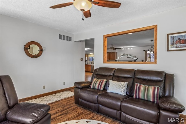 13145 Wanda Lee Ln, Saint Genevieve, MO 63670 - living room featuring a ceiling fan, wood finished floors, baseboards, and a textured ceiling