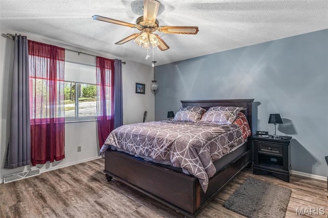 13145 Wanda Lee Ln, Saint Genevieve, MO 63670 - bedroom with wood finished floors, a textured ceiling, baseboards, and ceiling fan