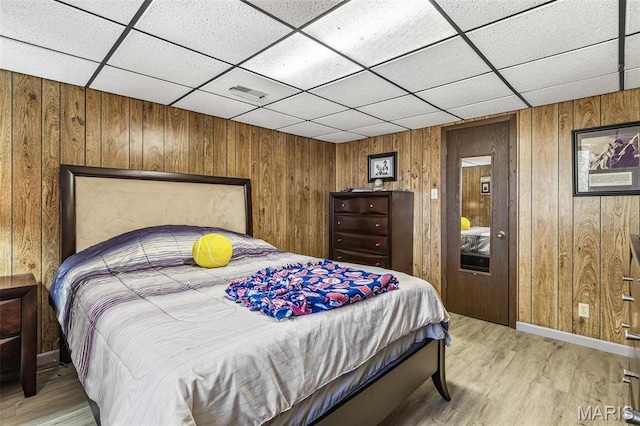 13145 Wanda Lee Ln, Saint Genevieve, MO 63670 - bedroom featuring a paneled ceiling, wood walls, light wood finished floors, and baseboards