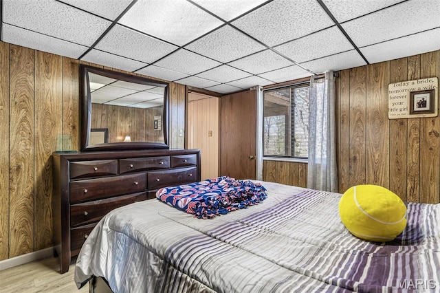 13145 Wanda Lee Ln, Saint Genevieve, MO 63670 - bedroom with wooden walls, wood finished floors, a drop ceiling, and baseboards
