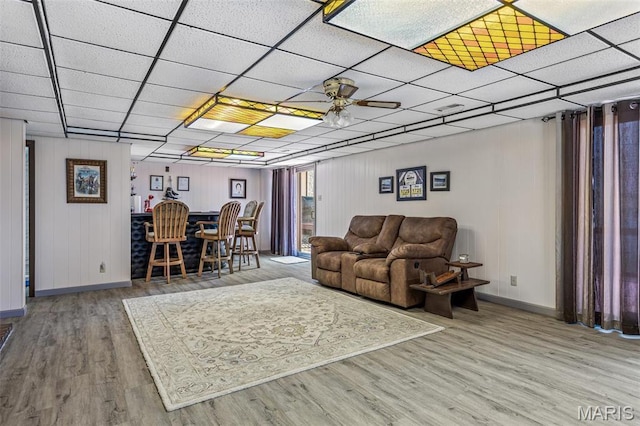 13145 Wanda Lee Ln, Saint Genevieve, MO 63670 - living area featuring baseboards, wood finished floors, a ceiling fan, and a paneled ceiling
