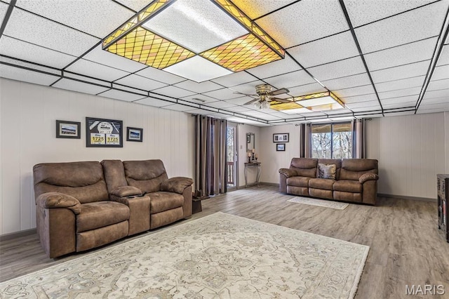 13145 Wanda Lee Ln, Saint Genevieve, MO 63670 - living area featuring wood finished floors, ceiling fan, baseboards, and a drop ceiling