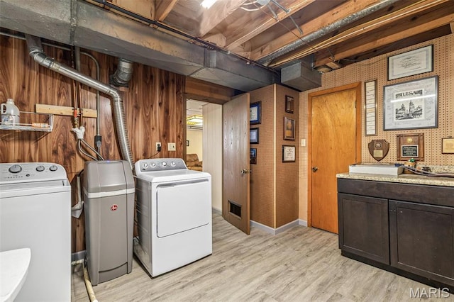 13145 Wanda Lee Ln, Saint Genevieve, MO 63670 - laundry room featuring washing machine and dryer, cabinet space, and light wood-type flooring