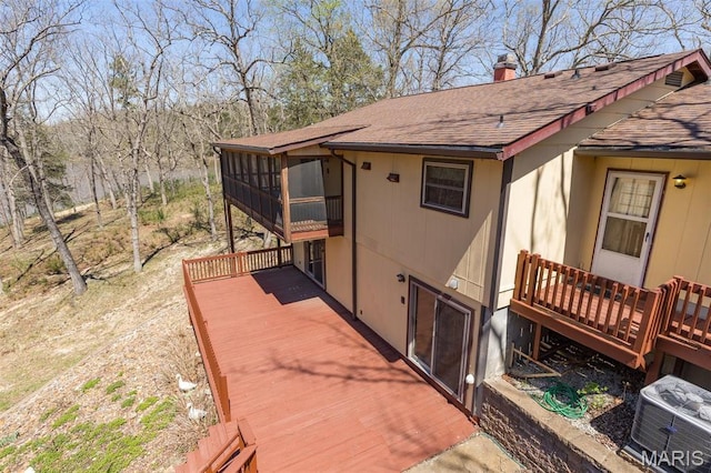 13145 Wanda Lee Ln, Saint Genevieve, MO 63670 - view of property exterior with roof with shingles, a deck, a sunroom, and a chimney