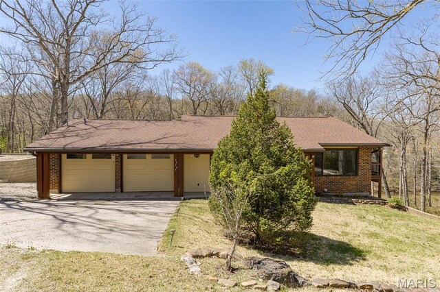 13145 Wanda Lee Ln, Saint Genevieve, MO 63670 - view of front facade featuring brick siding, asphalt driveway, a garage, a shingled roof, and a front lawn