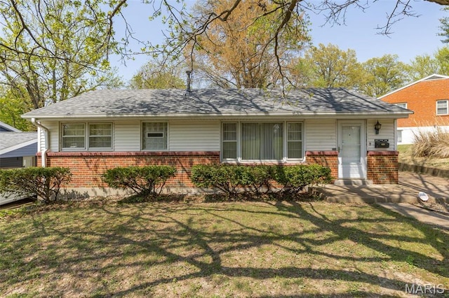 8907 Spur Ln, Saint Louis, MO 63121 - view of front of house featuring brick siding, a front lawn, and roof with shingles