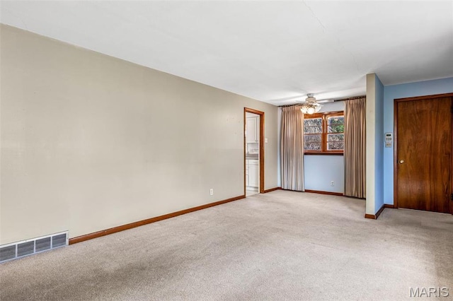 8907 Spur Ln, Saint Louis, MO 63121 - spare room with light colored carpet, baseboards, and a ceiling fan