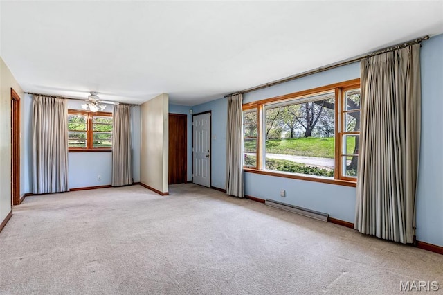 8907 Spur Ln, Saint Louis, MO 63121 - carpeted spare room featuring a baseboard radiator, baseboards, and a ceiling fan