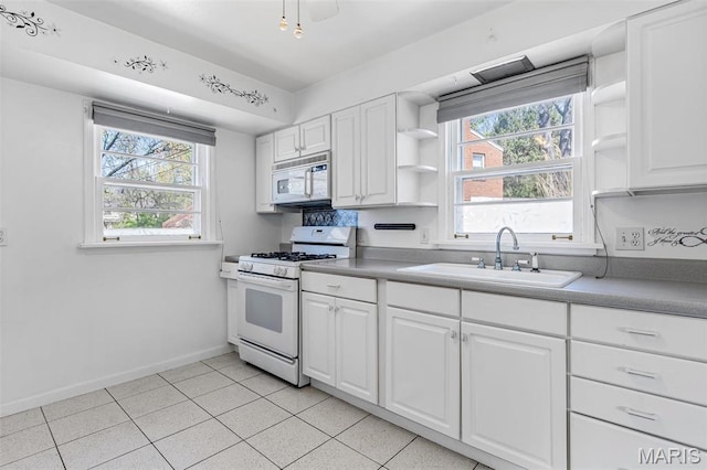 8907 Spur Ln, Saint Louis, MO 63121 - kitchen with white appliances, a sink, open shelves, and plenty of natural light