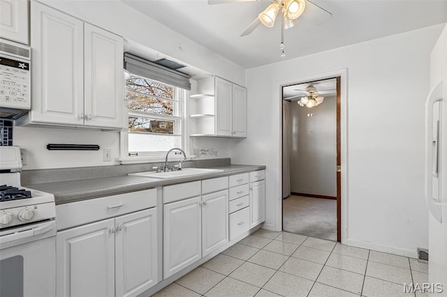 8907 Spur Ln, Saint Louis, MO 63121 - kitchen with a sink, white appliances, a ceiling fan, and white cabinets