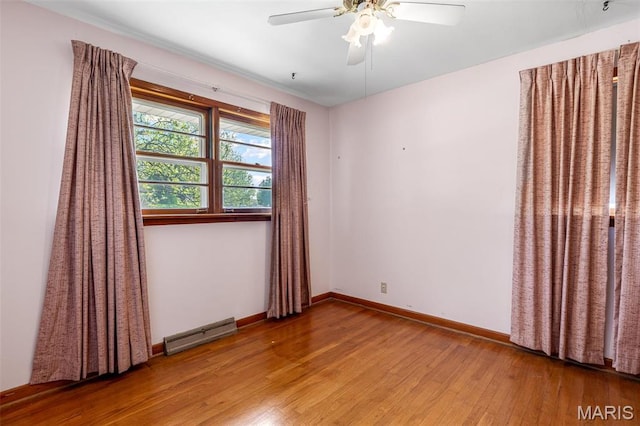 8907 Spur Ln, Saint Louis, MO 63121 - spare room featuring wood finished floors, a ceiling fan, and baseboards