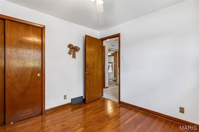 8907 Spur Ln, Saint Louis, MO 63121 - unfurnished bedroom with baseboards and wood finished floors