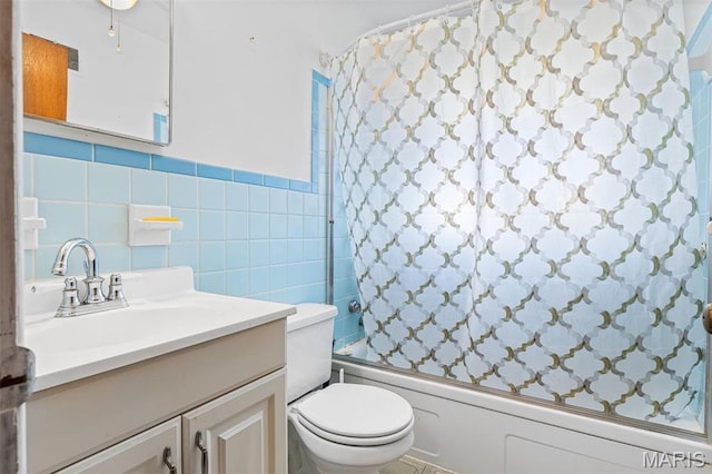 8907 Spur Ln, Saint Louis, MO 63121 - full bath featuring tile walls, combined bath / shower with glass door, vanity, and toilet