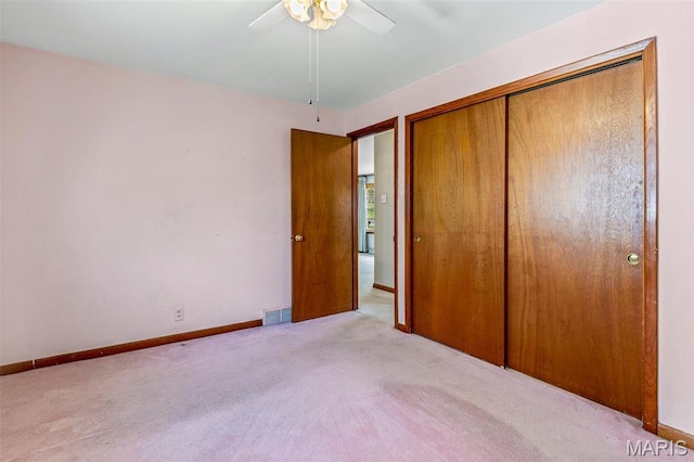 8907 Spur Ln, Saint Louis, MO 63121 - unfurnished bedroom with carpet, a closet, baseboards, and a ceiling fan