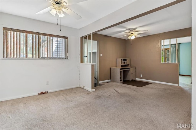 8907 Spur Ln, Saint Louis, MO 63121 - unfurnished living room featuring ceiling fan, carpet floors, and baseboards