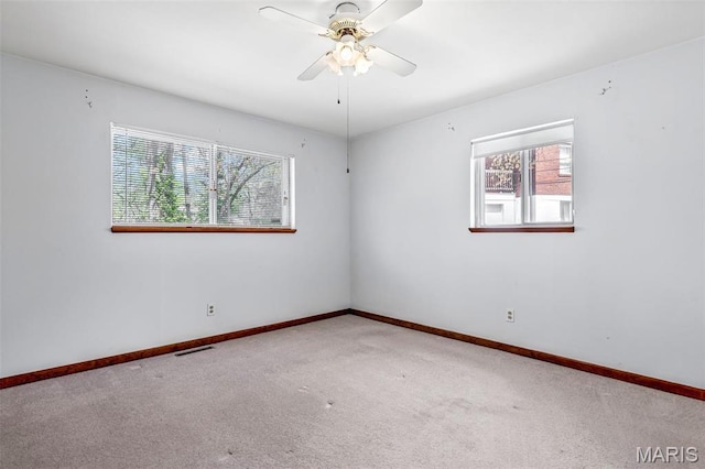 8907 Spur Ln, Saint Louis, MO 63121 - spare room with carpet floors, baseboards, and a ceiling fan