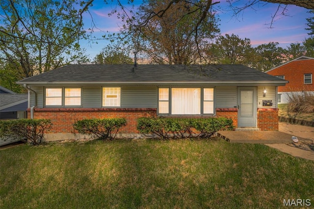 8907 Spur Ln, Saint Louis, MO 63121 - view of front of house with brick siding and a front yard