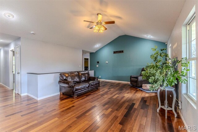 20373 Heritage Rd, Saint Robert, MO 65584 - living area featuring wood-type flooring, a ceiling fan, vaulted ceiling, plenty of natural light, and baseboards