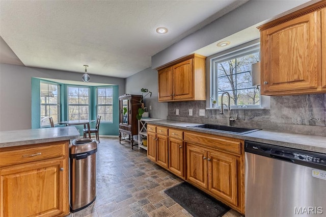 20373 Heritage Rd, Saint Robert, MO 65584 - kitchen with dishwasher, a sink, decorative backsplash, healthy amount of natural light, and a textured ceiling