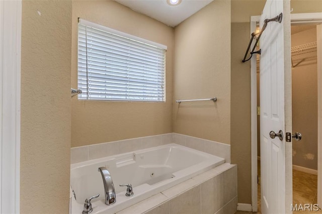 20373 Heritage Rd, Saint Robert, MO 65584 - bathroom featuring a whirlpool tub and a textured wall