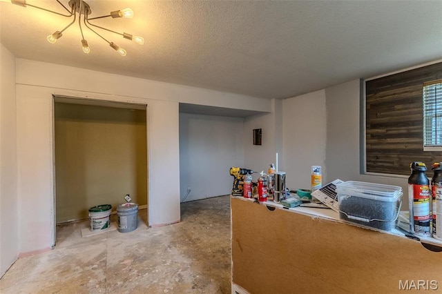 20373 Heritage Rd, Saint Robert, MO 65584 - office area with unfinished concrete flooring, a textured ceiling, and a chandelier