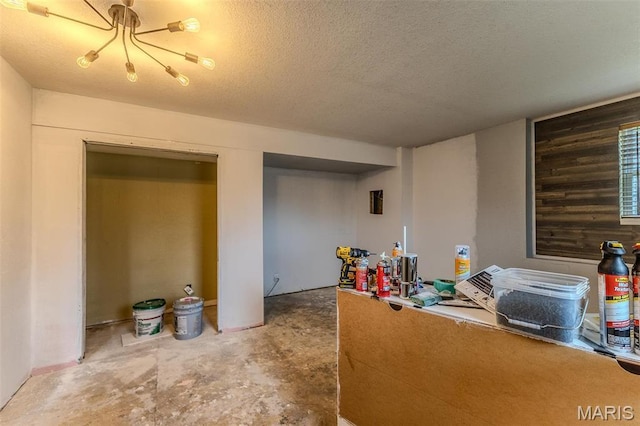 20373 Heritage Rd, Saint Robert, MO 65584 - office featuring a textured ceiling, a chandelier, and concrete flooring