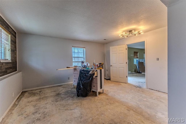 20373 Heritage Rd, Saint Robert, MO 65584 - unfurnished room featuring plenty of natural light, a textured ceiling, and concrete flooring