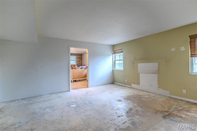 20373 Heritage Rd, Saint Robert, MO 65584 - spare room with unfinished concrete floors and a textured ceiling