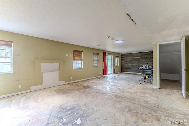 20373 Heritage Rd, Saint Robert, MO 65584 - unfurnished living room with baseboards and unfinished concrete floors