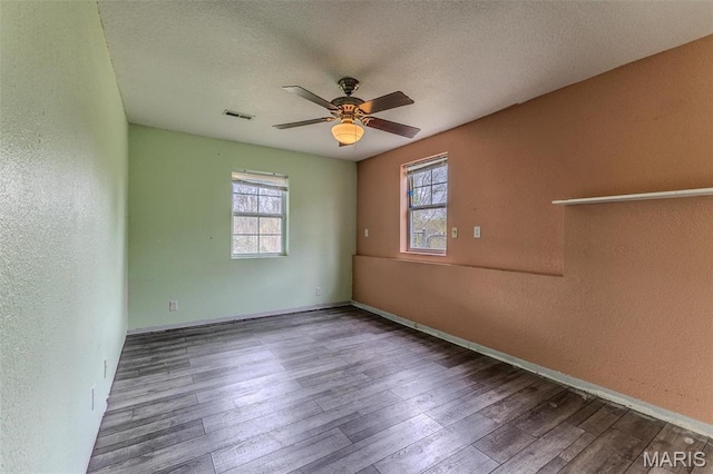20373 Heritage Rd, Saint Robert, MO 65584 - spare room with a textured wall, a ceiling fan, wood finished floors, baseboards, and a textured ceiling