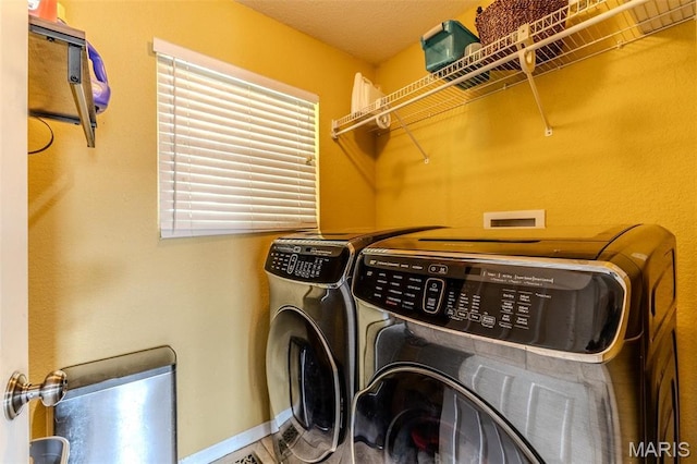 20373 Heritage Rd, Saint Robert, MO 65584 - washroom featuring washing machine and clothes dryer and baseboards